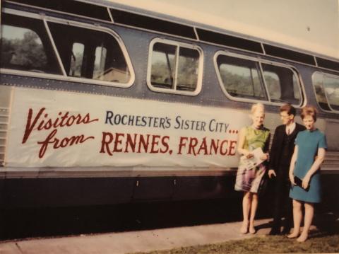 Visitors from Rennes, France standing in front of a bus in Rochester in 1967