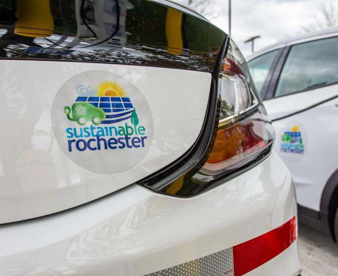 Photo of a Sustainable Rochester bumper sticker on an electric vehicle.
