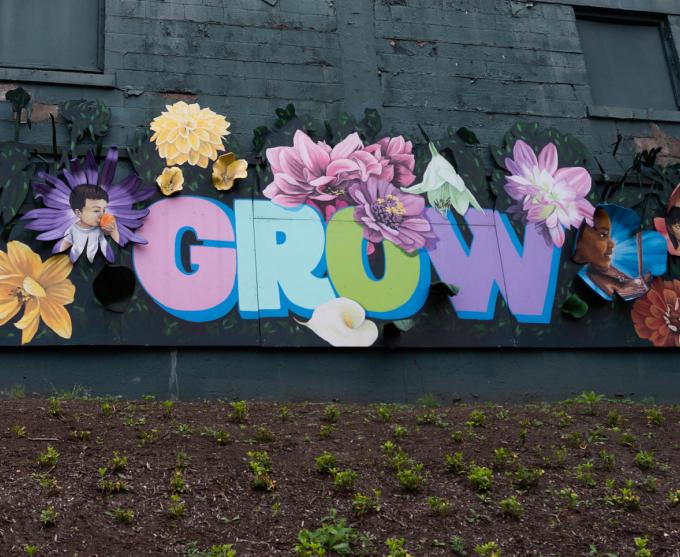 Photo of a mural that says "grow" in Rochester's northeast quadrant.