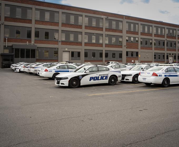 Photo of Rochester police cars parked in a lot.