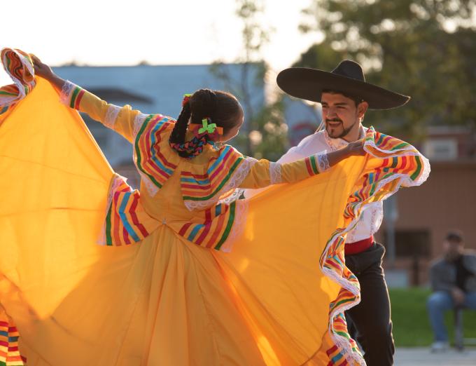 Photograph of two people dancing to celebrate Hispanic Heritage Month in Rochester.