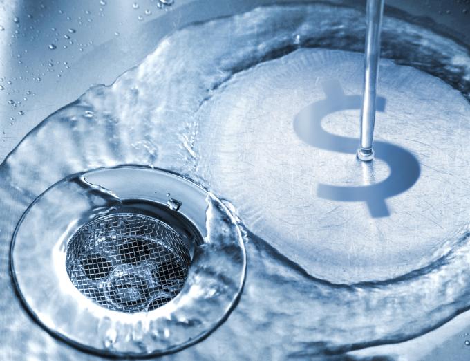 Photo illustration of a money sign in a sink.