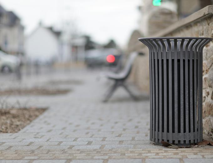 A photo of a litter basket on a city street.
