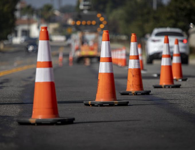 Photo of traffic cones at a street construction site.