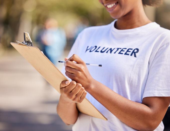 Photo of a volunteer holding a clipboard.