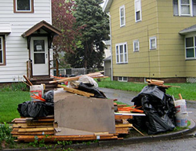 Photo of garbage piled on a curb.