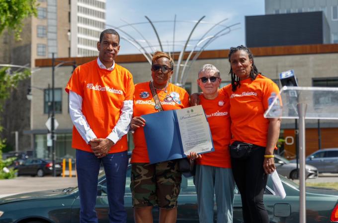 Photo of Mayor Malik Evans and others wearing orange for gun violenve awareness.