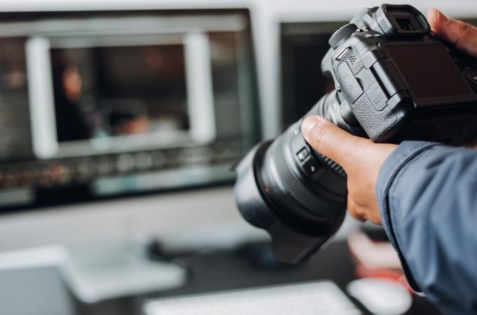 A photo of a person holding a camera.