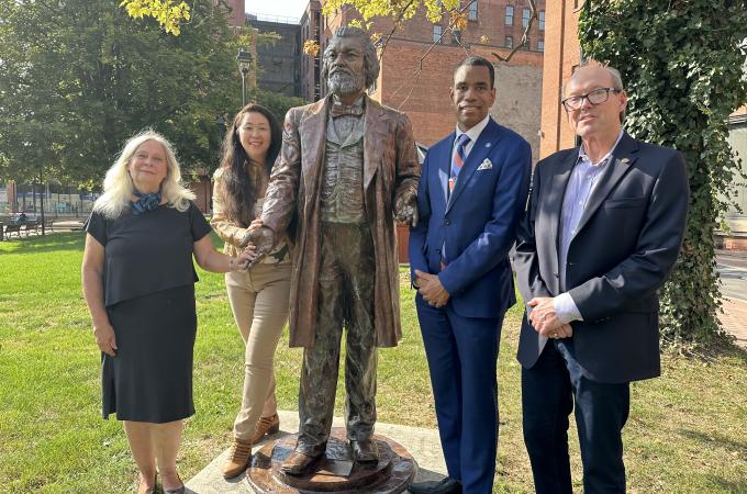 Mayor Evans, Peter Landers, Olivia Kim and Chris Christopher stand with the Frederick Douglass statue in Aqueduct Park