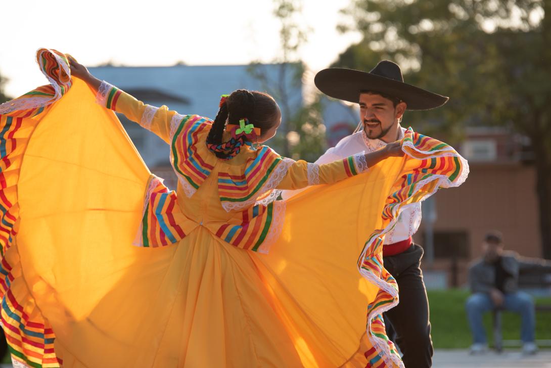 Photograph of two people dancing to celebrate Hispanic Heritage Month in Rochester.