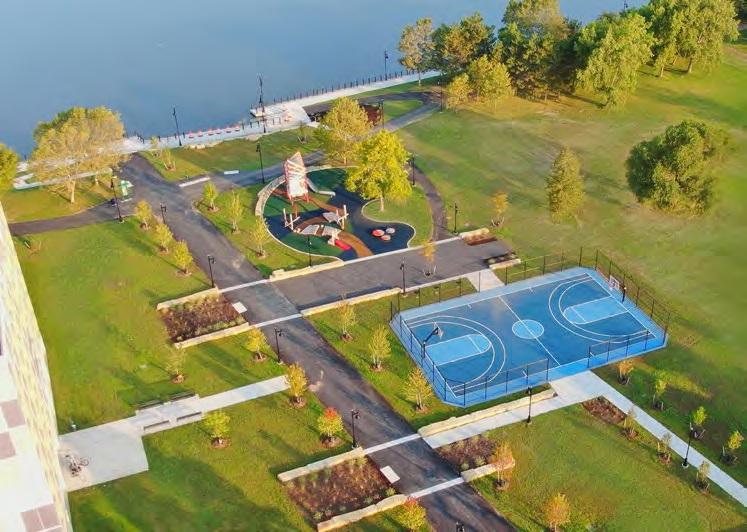 Aerial photo of newly installed playground and basketball court at Genesee Gateway park including a view of the riverfront.
