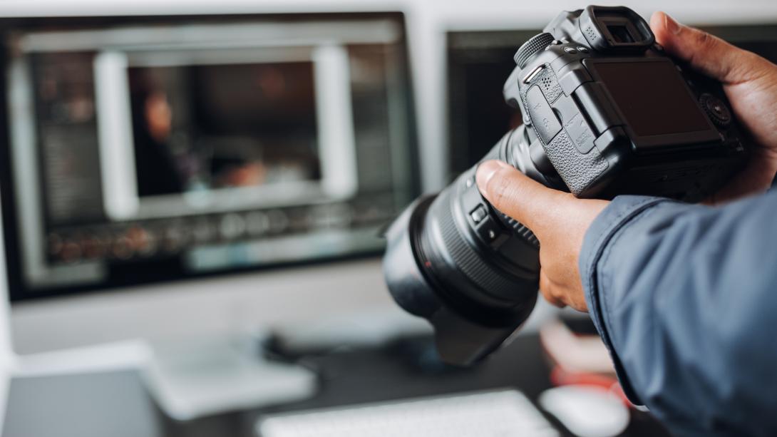 A photo of a person holding a camera.