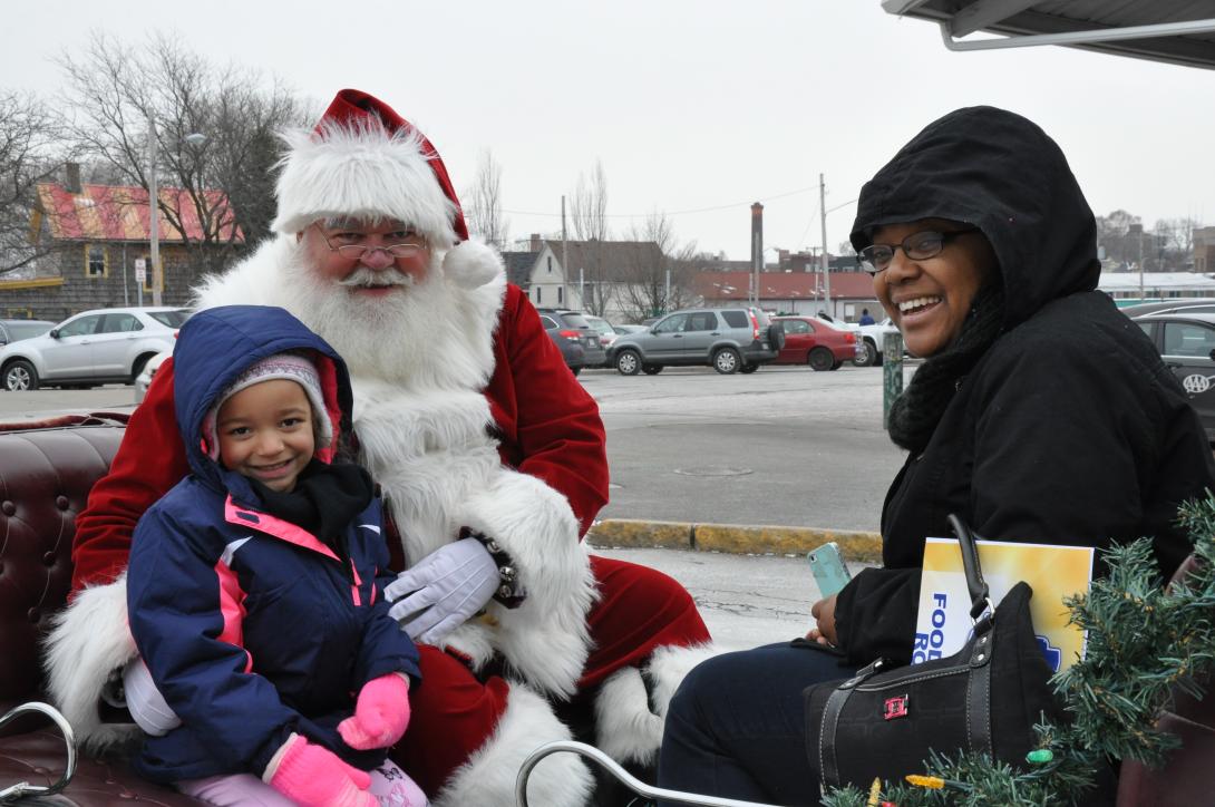 Santa and a family at Holidays at the Market